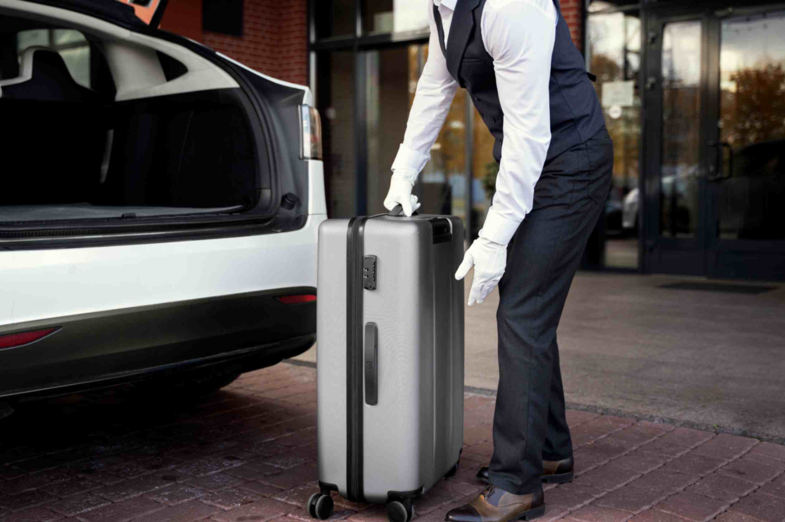 Jpeg optimizer side view valet holding baggage